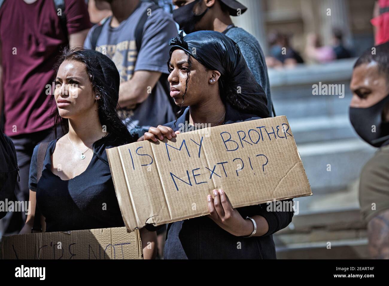 GREAT BRITAIN / England / London /  Two female anti-racism protester holding sign' Is my brother next' ? Stock Photo