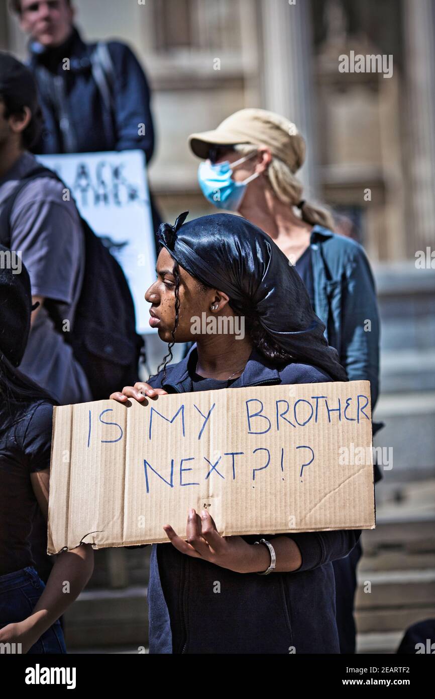 GREAT BRITAIN / England / London /  Black female anti-racism protester holding sign Is my brother next . Stock Photo