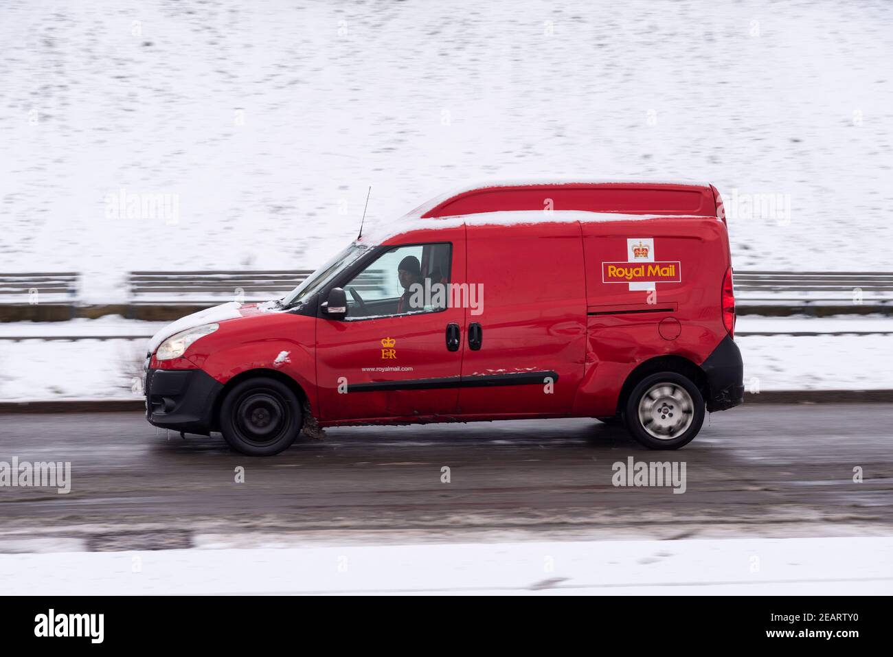 Royal Mail post van driving along the seafront at Southend on Sea, Essex, UK, with snow on the ground from Storm Darcy Stock Photo