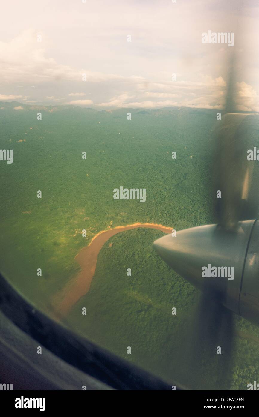 Winding Amazon river out window of small propellor plane Stock Photo
