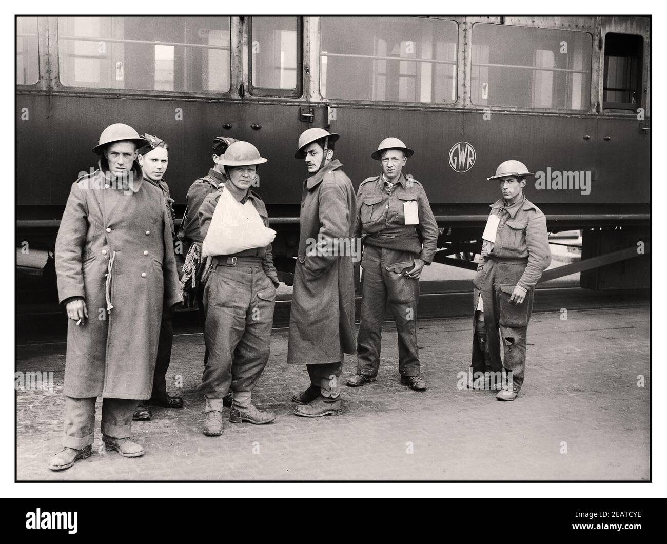 DUNKIRK TROOPS WW2 group of 'walking wounded' British troops evacuated from Dunkirk, in front of a GWR railway carriage at Dover, 31 May 1940. World War II Stock Photo
