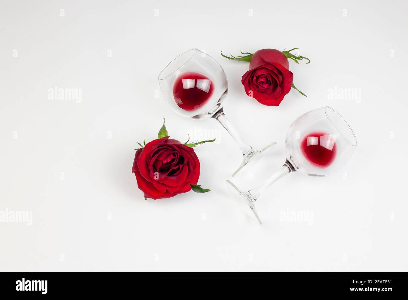 https://c8.alamy.com/comp/2EATF51/red-roses-and-wine-glasses-with-red-wine-on-white-background-holidays-and-valentins-day-romantic-flat-lay-top-view-concept-2EATF51.jpg