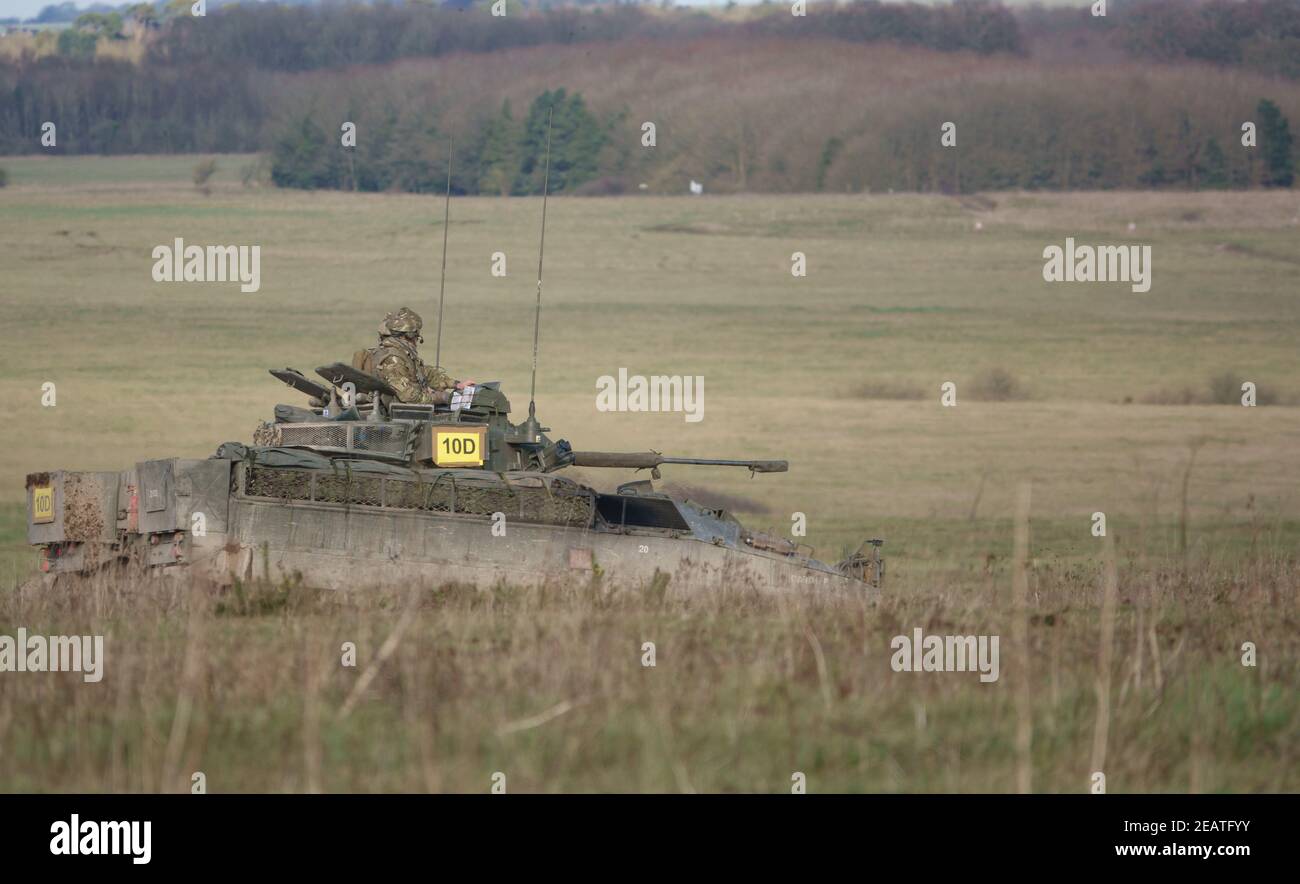British Army Warrior light infantry battle tank on maneuvers in a demonstration of firepower, Salisbury Plain Stock Photo