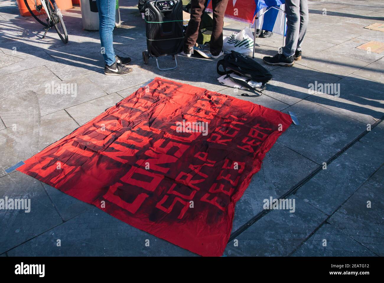Student Rent Strike, Lower Marsh Street, London, UK 10th February 2021. a banner stating 'students not consumers' lies on the floor at the feet of protestors Credit: Denise Laura Baker/Alamy Live News Stock Photo