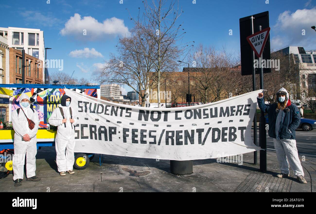 Student Rent Strike, Lower Marsh Street, London, UK 10th February 2021. Students dressed in hazmat suits and masks hold banners stating that the are 'students not consumers'. They are protesting against having to pay high rents and fees, while receiving little in the way of tuition or accommodation due to the ongoing Covid 19 Pandemic Credit: Denise Laura Baker/Alamy Live News Stock Photo