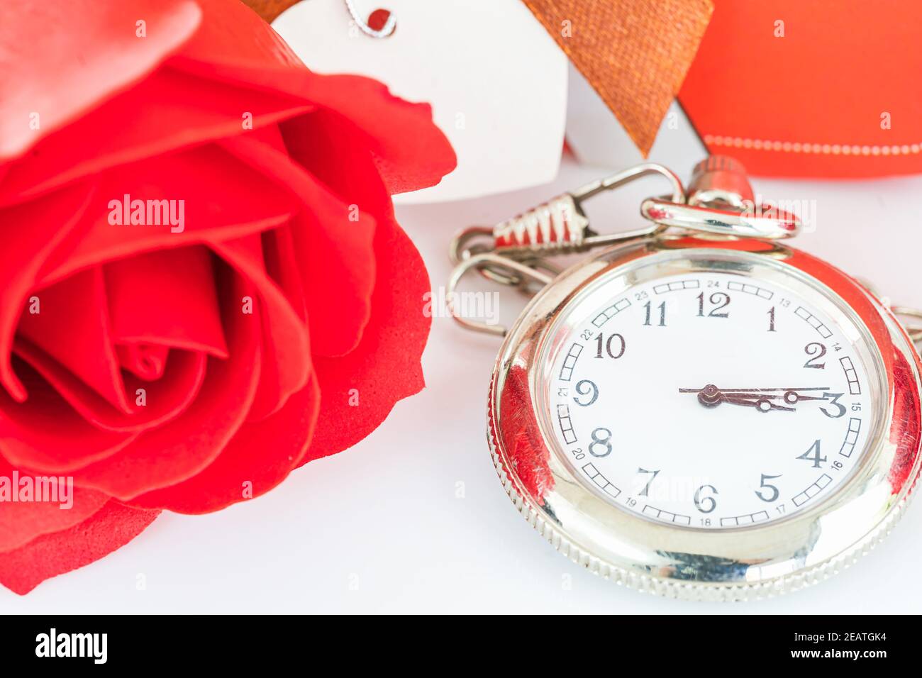 Close up pocket watch and red roses flower Stock Photo