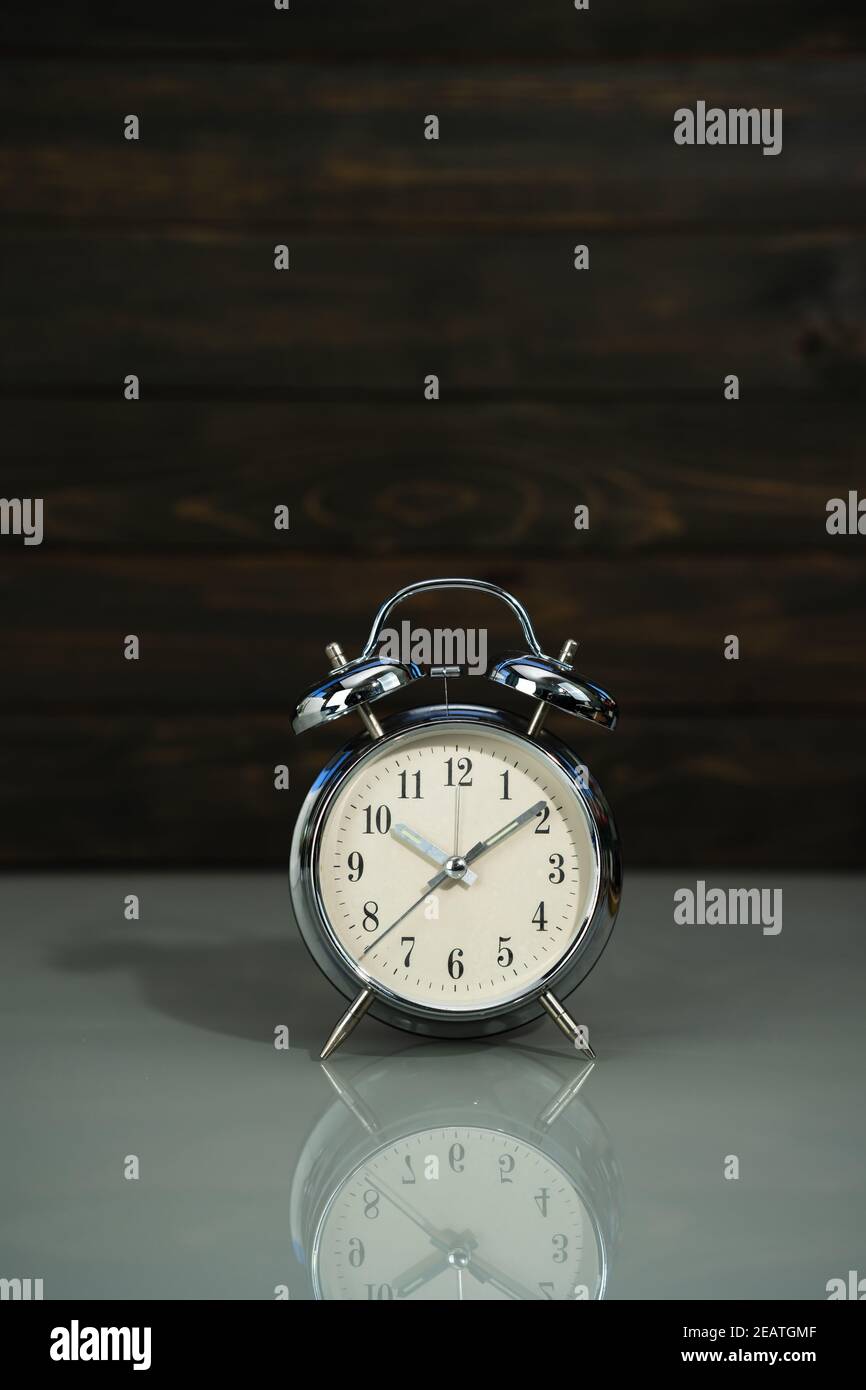 Retro alarm clock on table Stock Photo