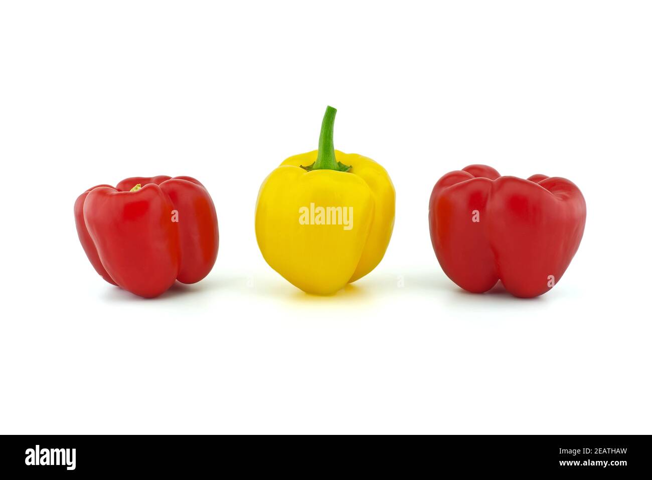 Red and yellow bell peppers on white background Stock Photo - Alamy