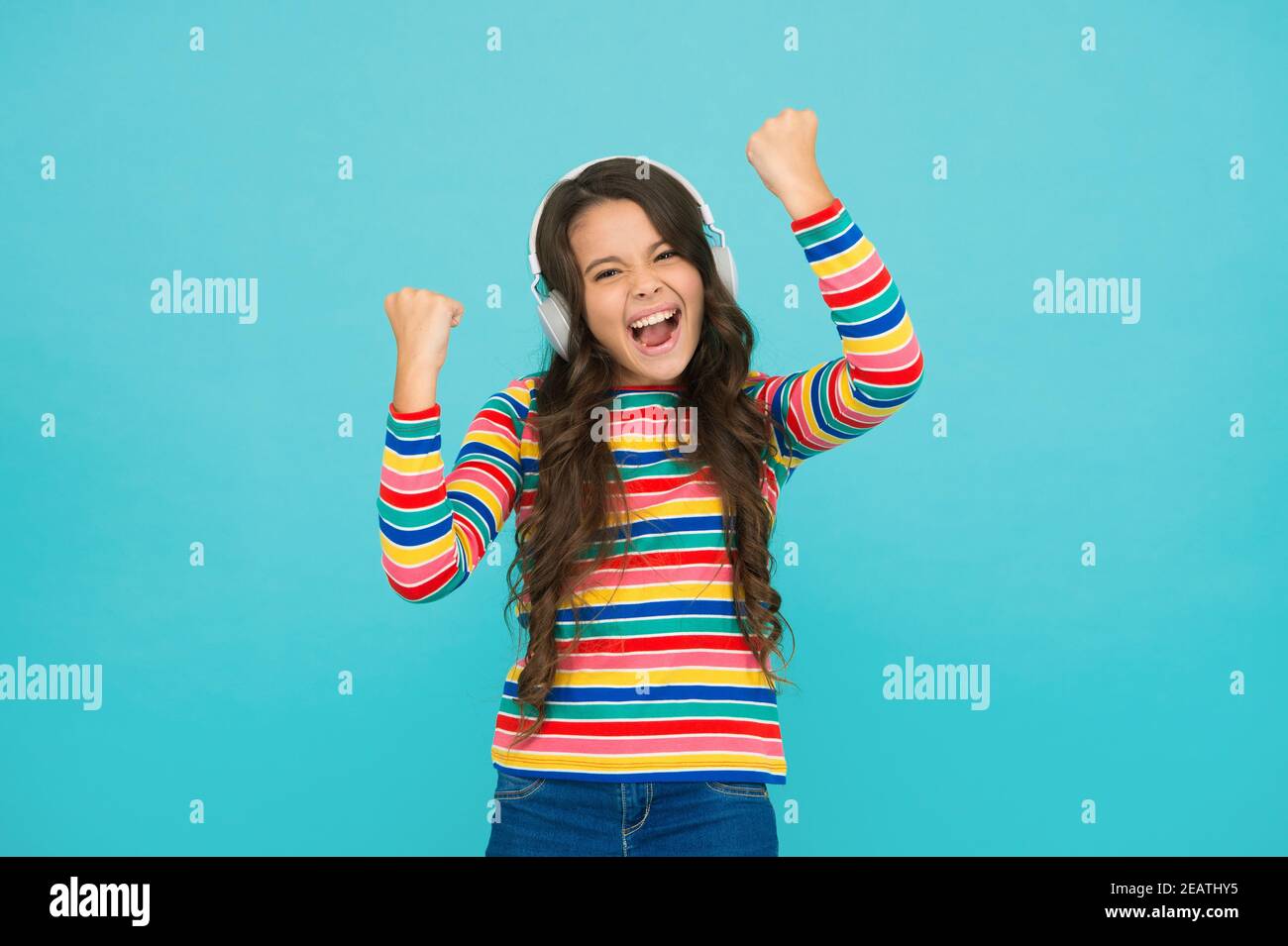 Melody to cheer up. Energetic rhythm concept. Good track improves mood.  Happy small girl listen music. Little child enjoy song playing in  headphones. Happy face. Music brings happy emotions Stock Photo -, image size:1300x955