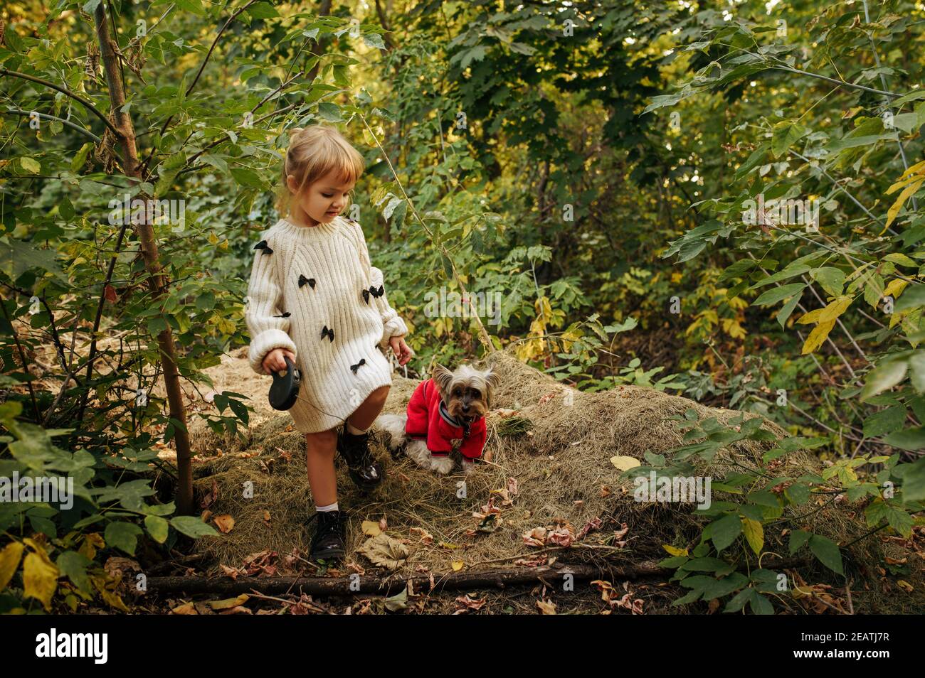 Kid with funny doggy walking in the garden Stock Photo