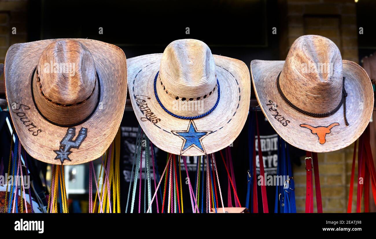 Souvenir straw cowboys hats for sale in San Antonio, Texas, personalized with names of three Texas-based professional sports teams. Stock Photo
