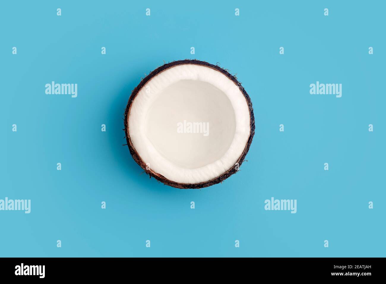 Coconuts on a blue isolate background. Coconut minimal concept. Stock Photo