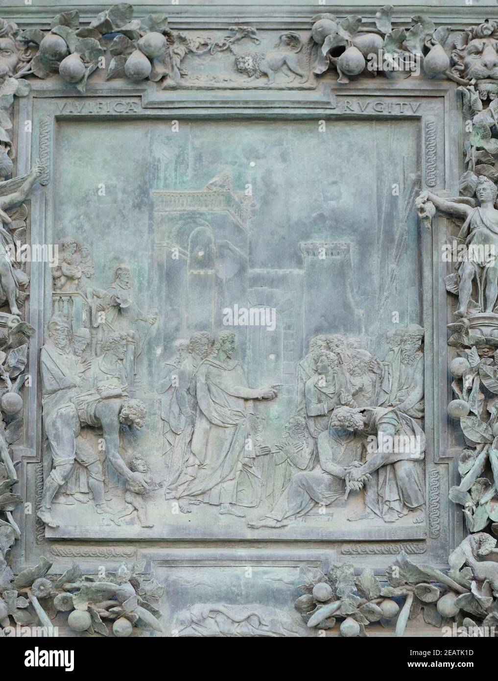 The payment of the tribute, sculpture work from Giambologna's school, collocated in the left portal panel of the Cathedral St. Mary of the Assumption in Pisa, Italy Stock Photo