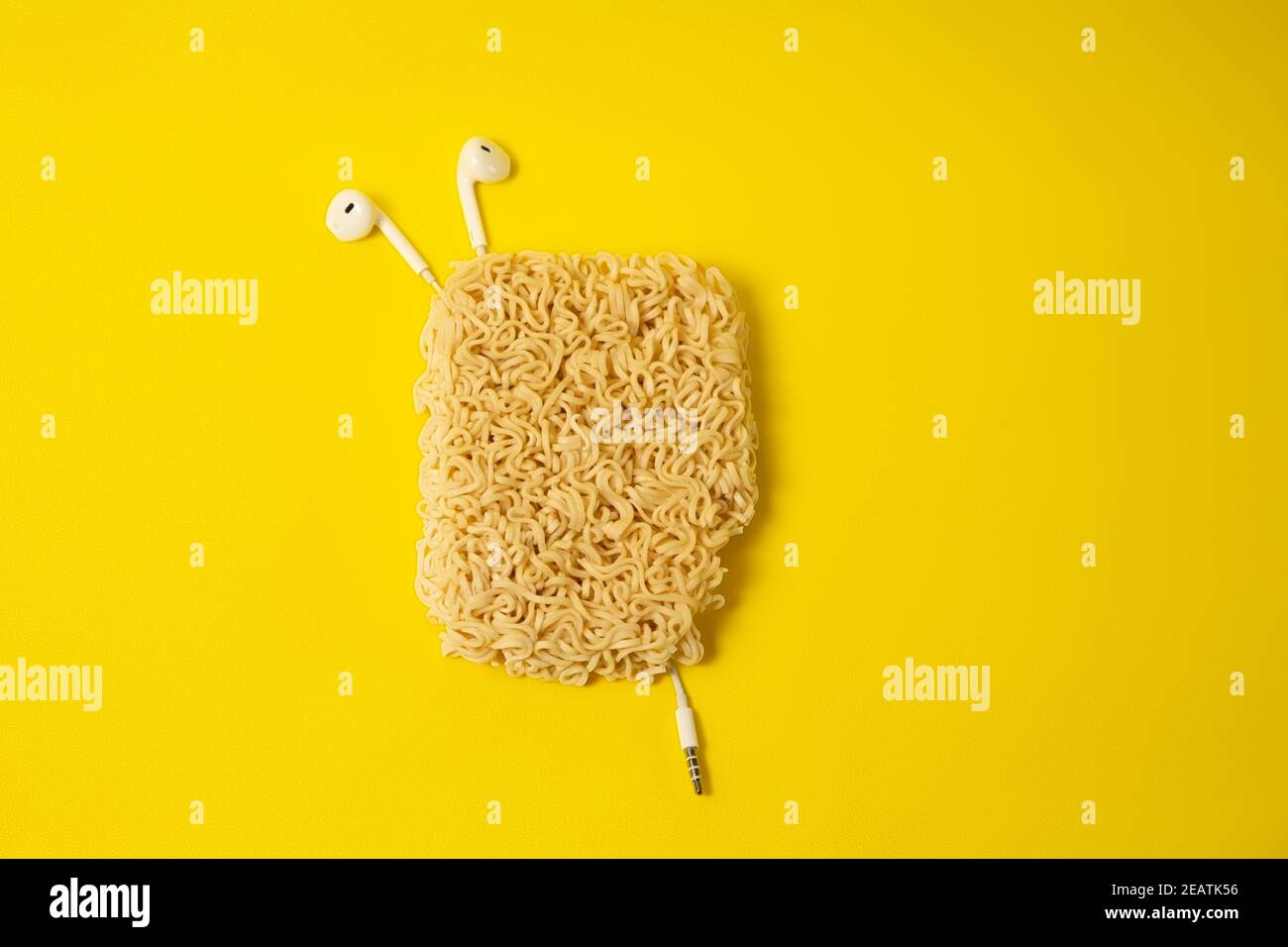 Headphones are all messed up, a bag of noodles. Fun and minimal color still life photography Stock Photo