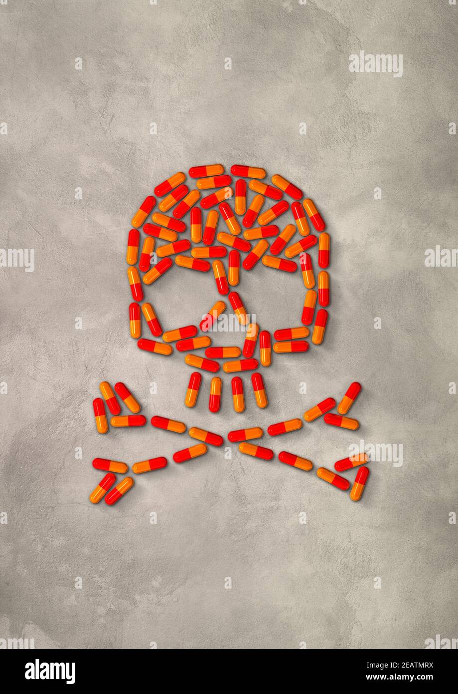 Skull made of orange capsule pills. Concrete background Stock Photo