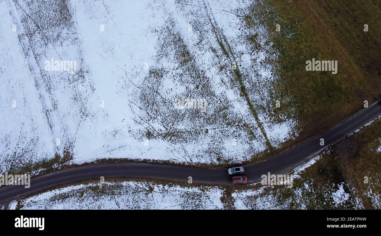 Drone photo of two cars passing each other in winter on narrow road Stock Photo