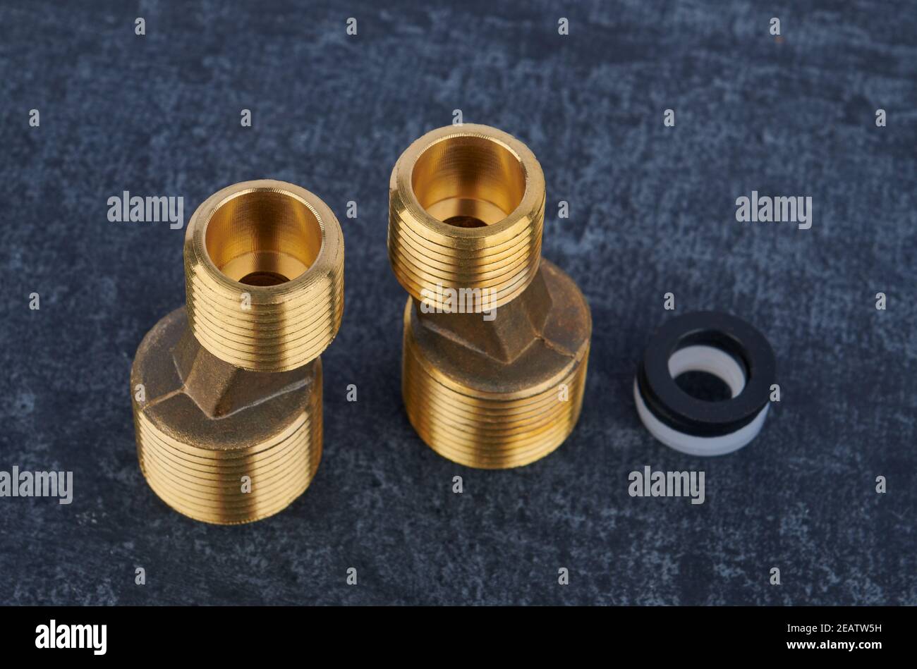 Eccentric connectors from brass for wall-mounted water faucet for installation, close-up, shallow depth of field Stock Photo