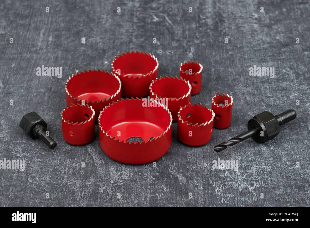 Set of saw crowns for work in wood, red color, close up, shallow depth of sharpness Stock Photo