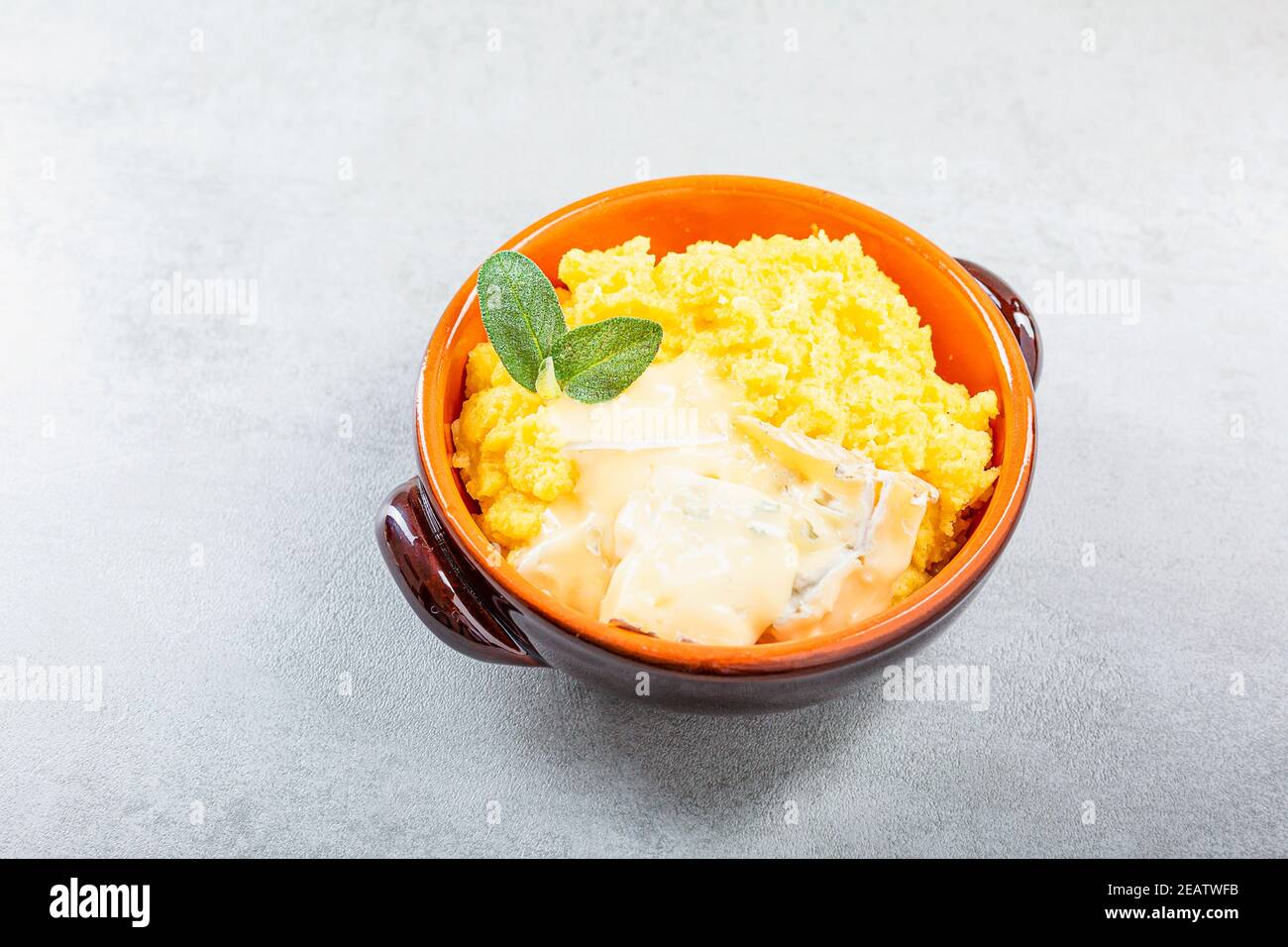 Dish of polenta with melted cheese Stock Photo Alamy