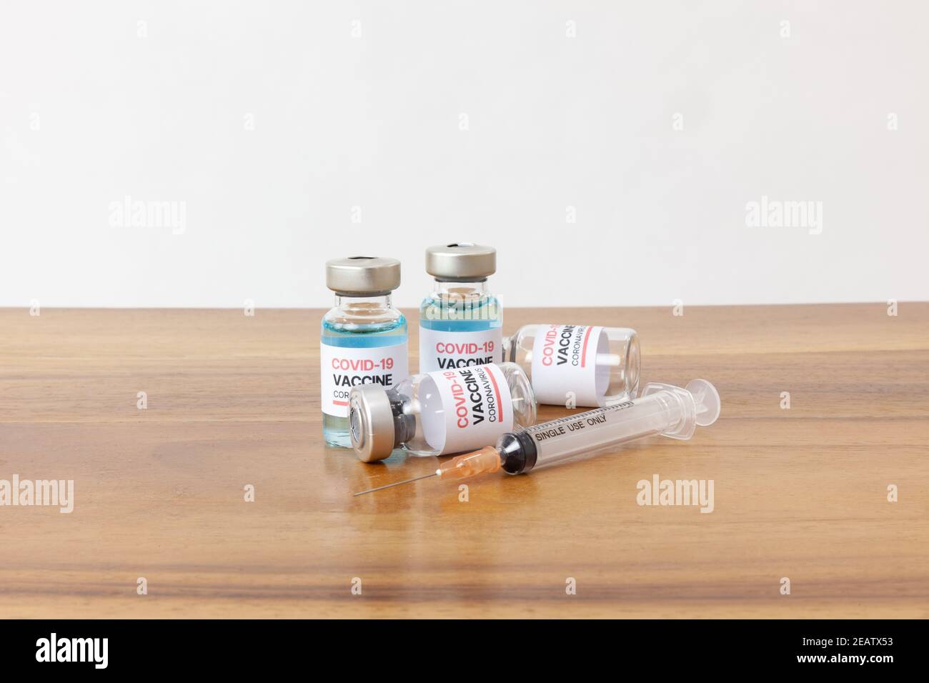 Concept of a Coronavirus covid -19 trial Multiple Vaccine Bottles with Needles Stock Photo