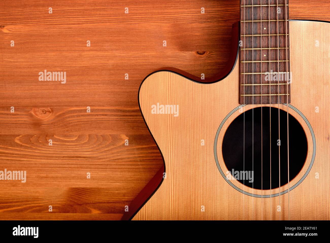Close-up western guitar on wooden background Stock Photo - Alamy