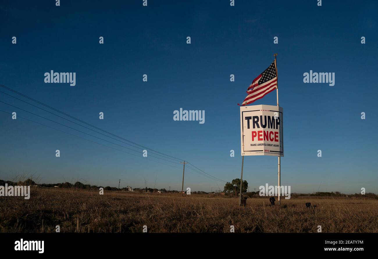 Smithville, Texas, USA. 2nd Feb, 2021. A farmer outside of Smithville in Bastrop County, TX flies a slightly tattered American flag over a Trump-Pence campaign sign three months after the November election where the Republican ticket lost. Many rural Texans still refuse to accept a Democratic victory. Credit: Bob Daemmrich/ZUMA Wire/Alamy Live News Stock Photo