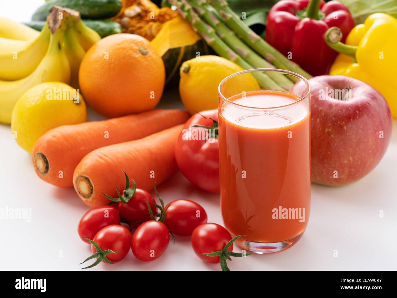 A variety of fruits and vegetables and a glass of vegetable juice Stock Photo