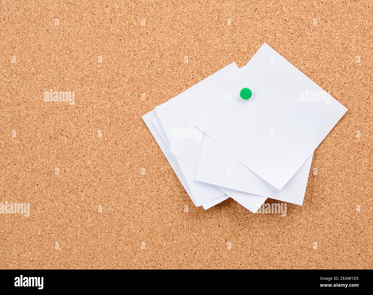 white square blank pieces of paper pinned on a cork board Stock Photo
