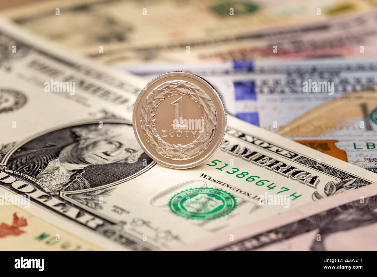 One Polish zloty coin on USA dollars currency banknotes exchange ...
