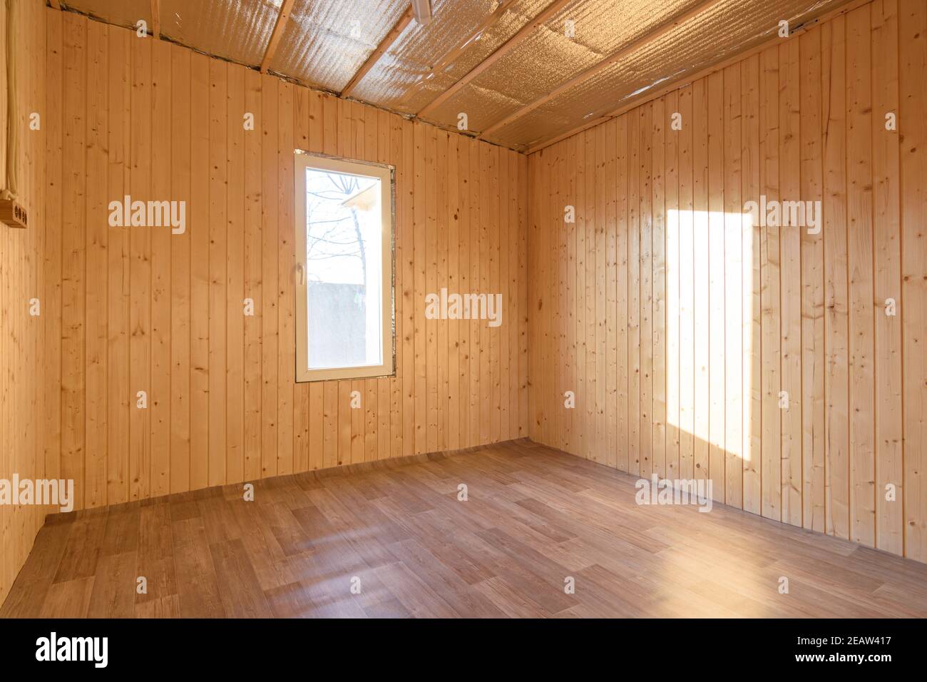 Empty room in a country house, sun rays fall on the wall from the ...