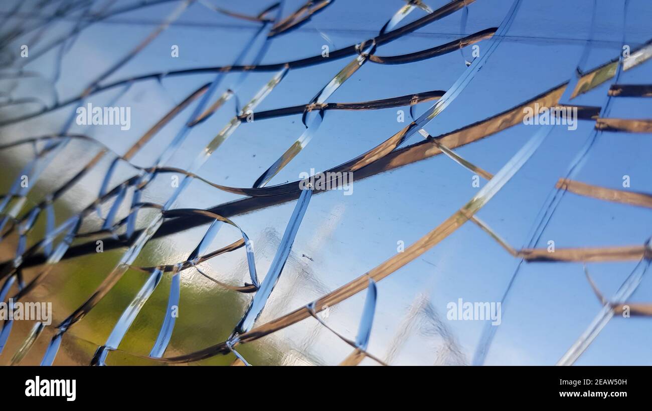 Closeup shot of the cracks on the glass of a window Stock Photo