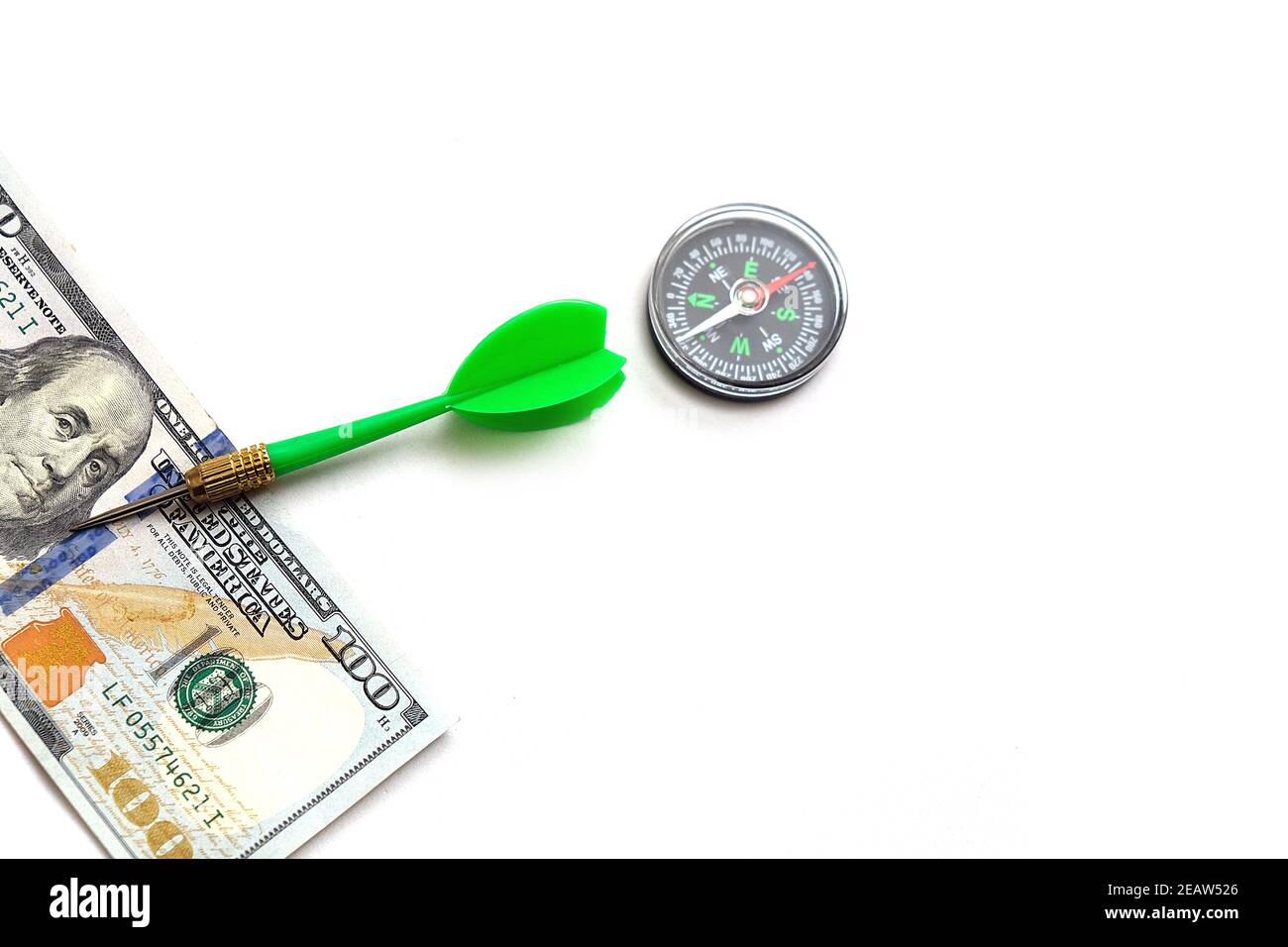 100 american dollars on a white background and compass, to make correct and accurate investment Stock Photo