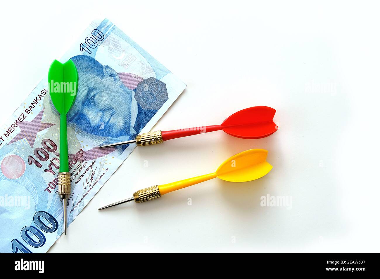 Investing with yellow, green and red darts and 100 Turkish lira on a