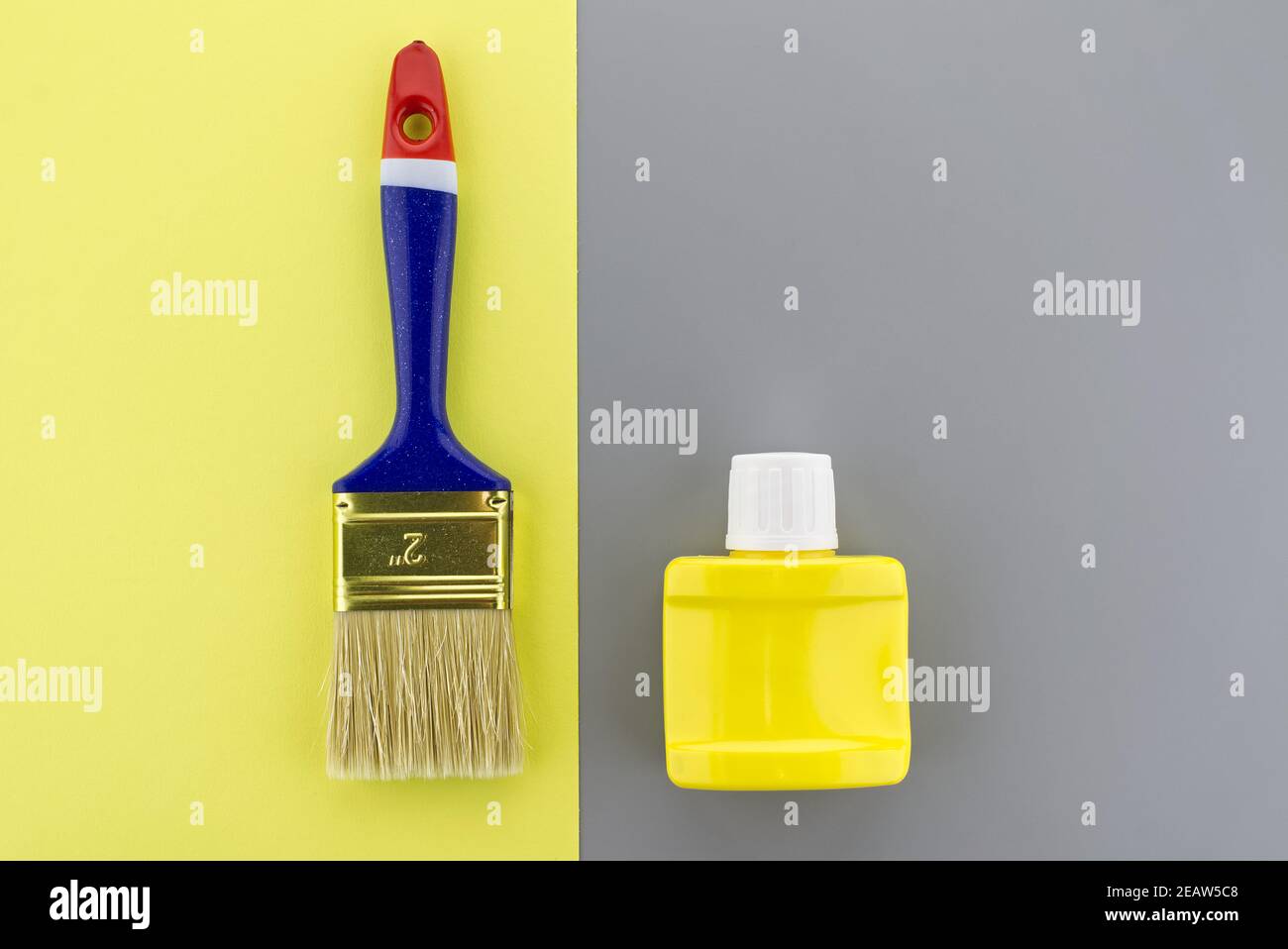 Paintbrush on two tone grey and yellow background Stock Photo