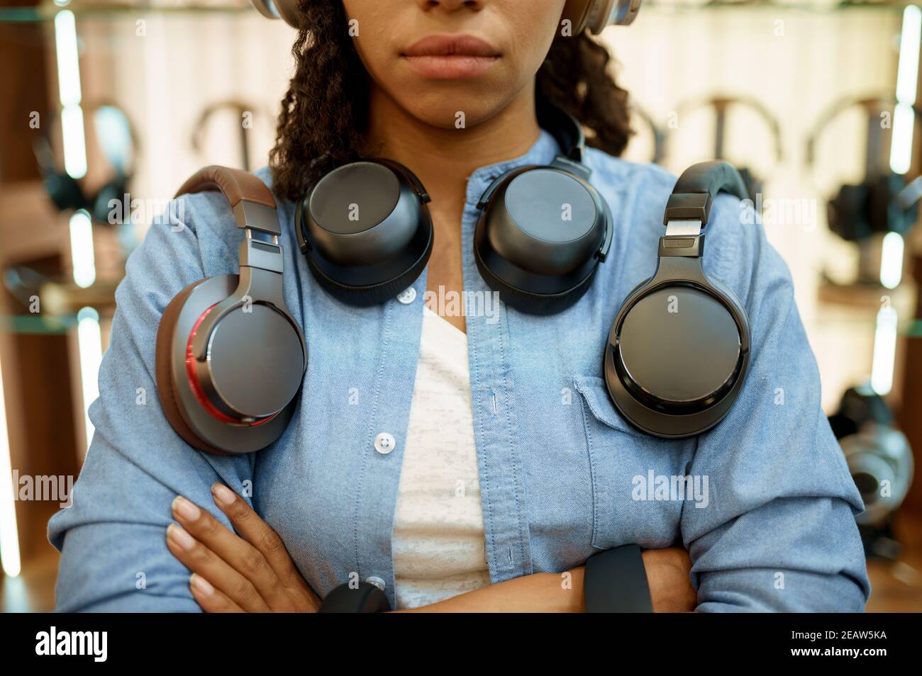Woman with headphones in audio store, music fan Stock Photo