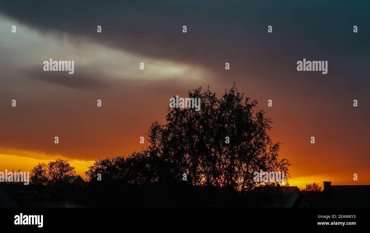 Beautiful orange sky at the sunset with clouds from a storm Stock Photo ...