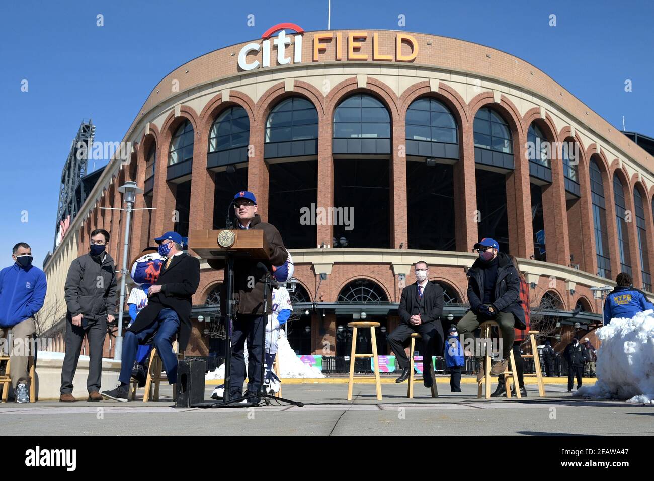 New York Mets owner Steve Cohen (at podium) speaks at a press