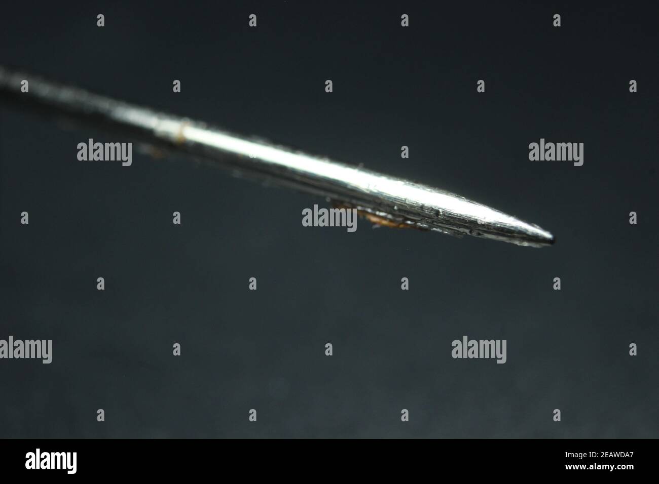 Macro photograph of sewing needle over the black background. Stock Photo