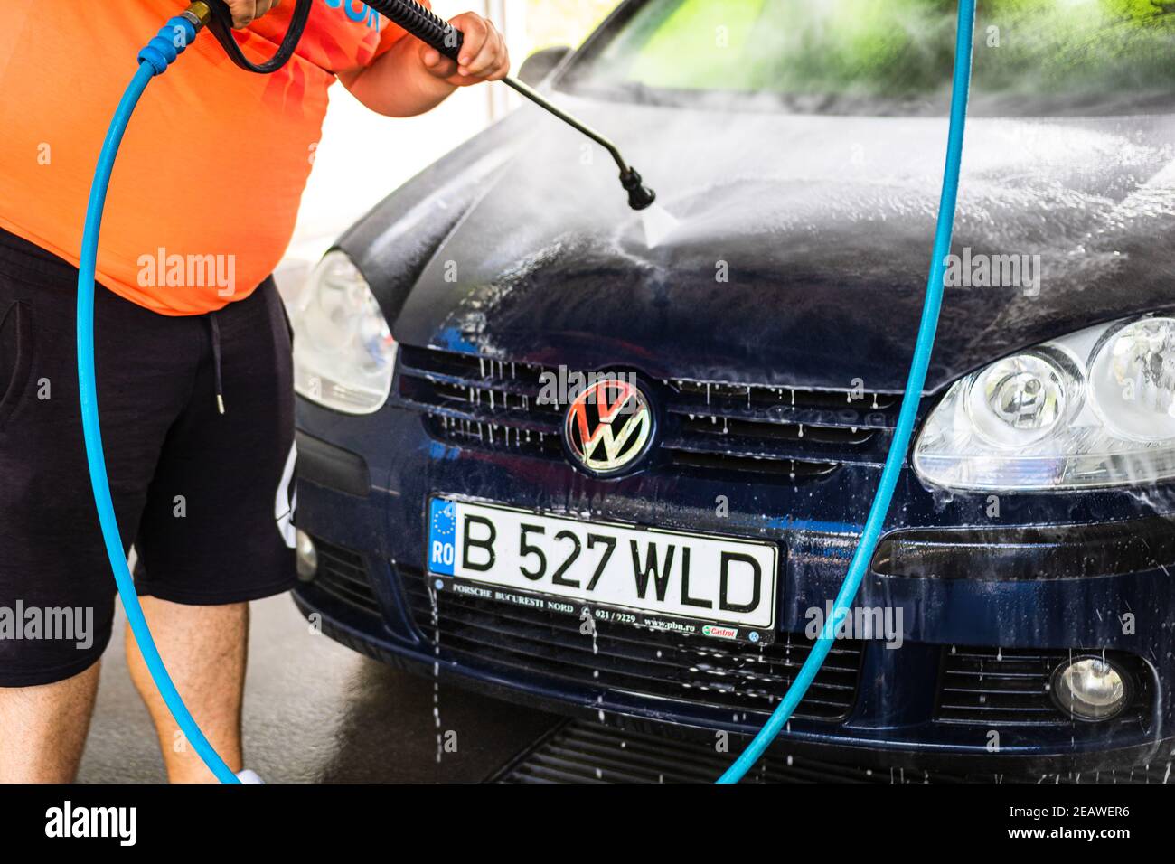 Washing and cleaning car in self service car wash station. Car washing