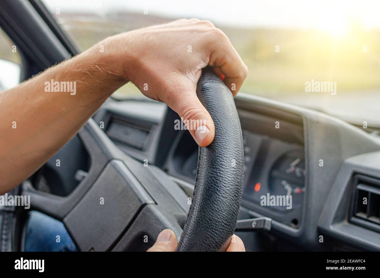 Driver keeps his hands on the steering wheel of the car Stock Photo Alamy