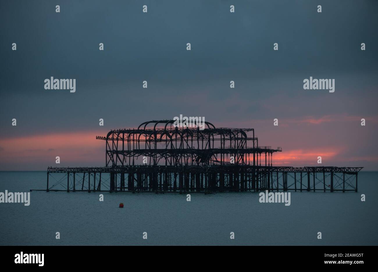 The sun sets behind West Pier in Brighton, UK, Feb 6, 2021 Stock Photo