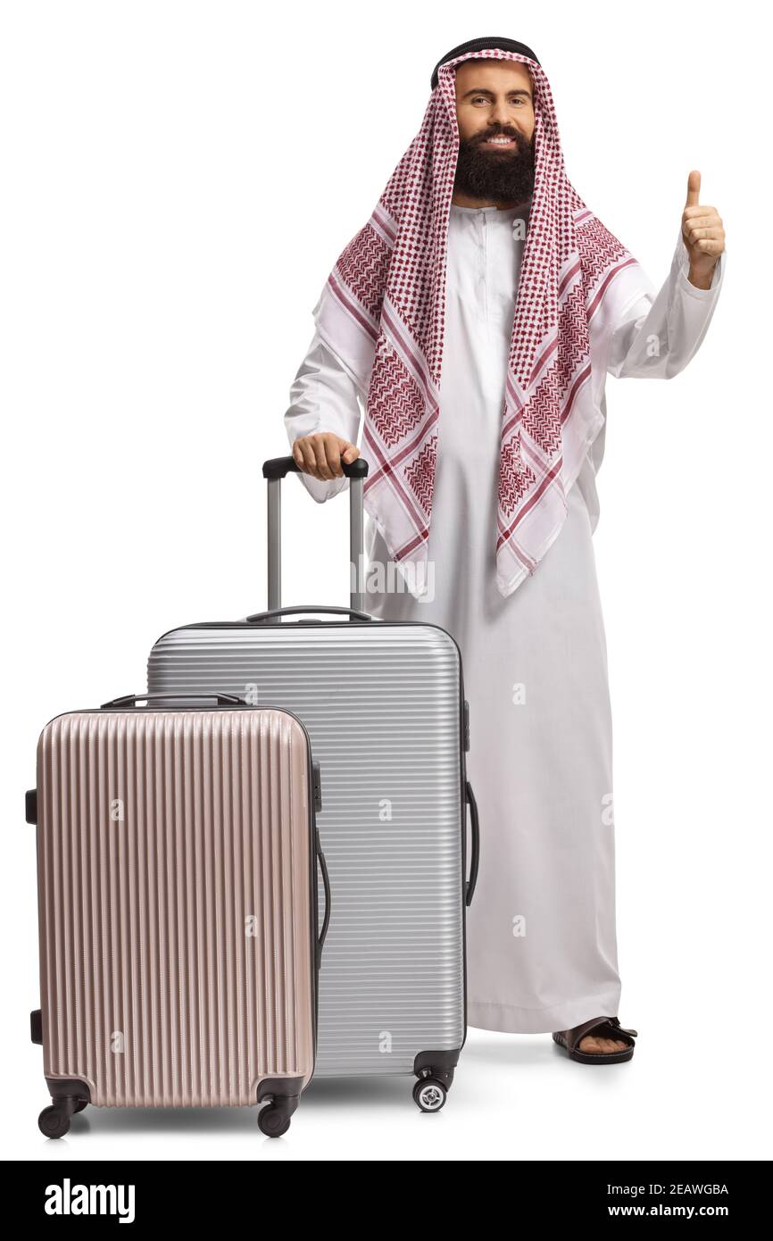 Full length portrait of a bearded arab man with suitcases showing thumbs up isolated on white background Stock Photo