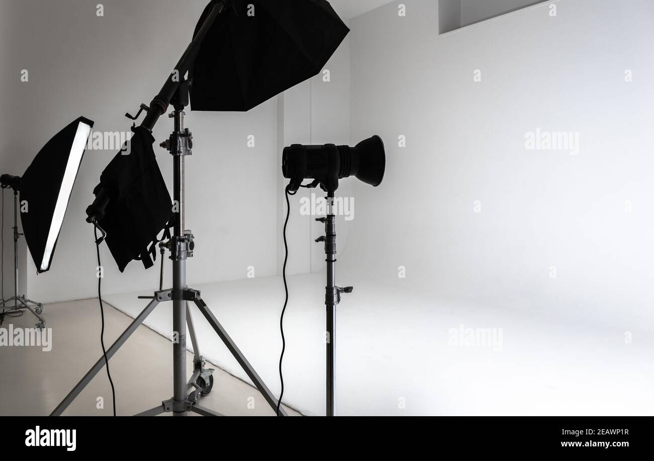 White photo studio interior, cyclorama background and set of professional impulse lights Stock Photo