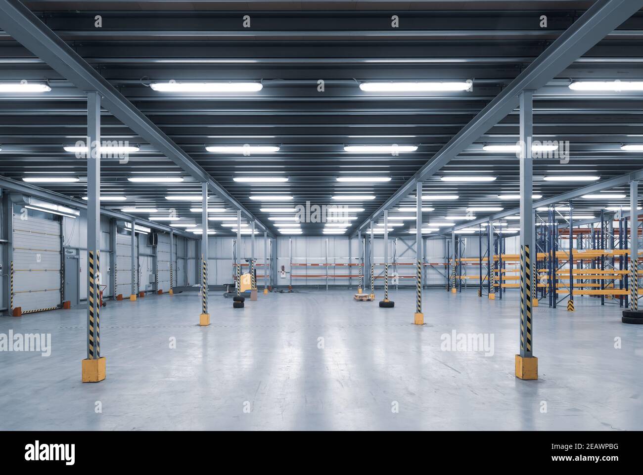 Interior of huge empty storehouse. Industrial warehouse racking. Stock Photo