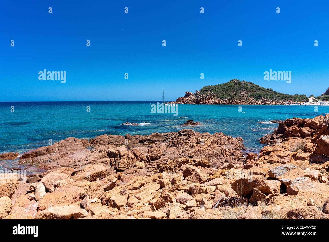 Red rocks, crystal clear water and centuries-old junipers on the beach of Su Sirboni, Sardinia Stock Photo