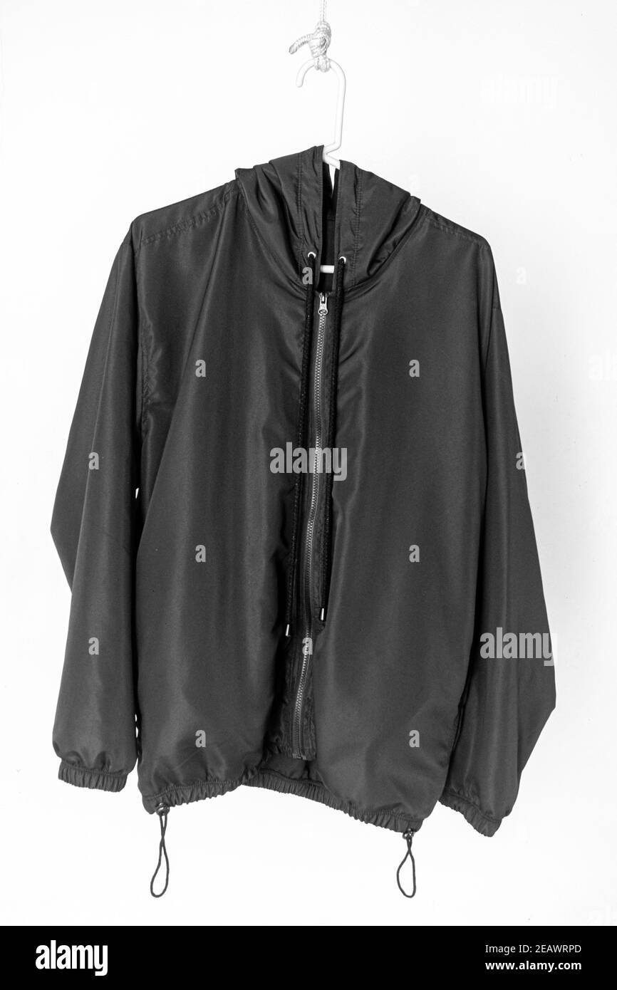 Black coat hanging isolated on a white background Stock Photo