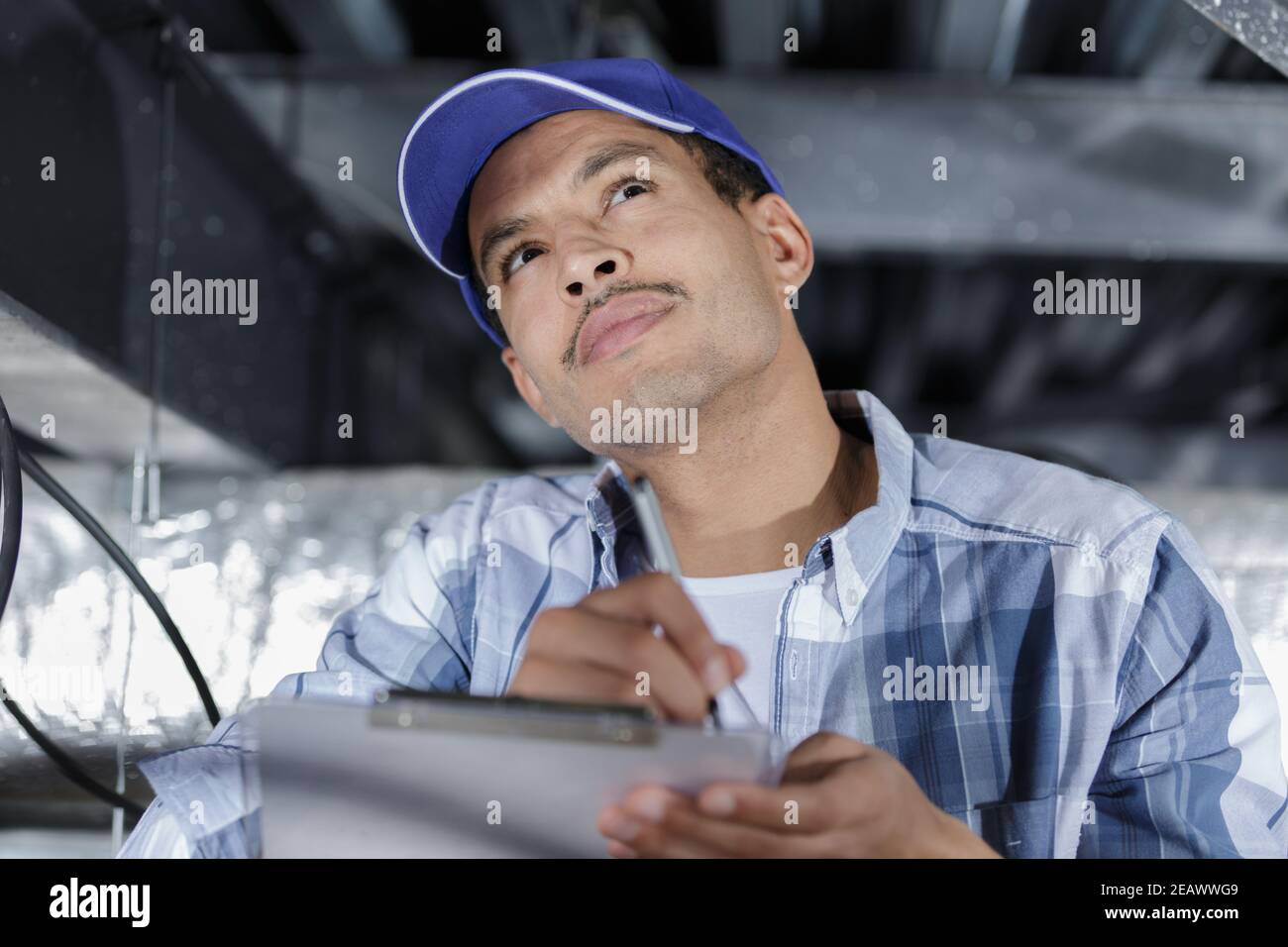 construction electrician checking roof cables Stock Photo Alamy