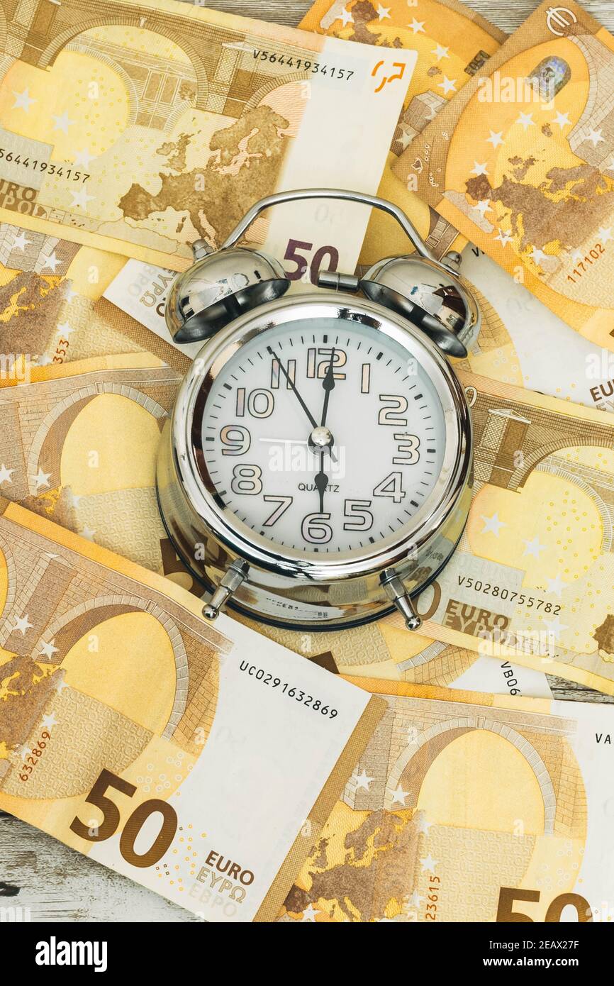 Detail Of An Analog Clock On A Background Of Euro Banknotes In Concept Of Time Is Money With A Vertical Picture Stock Photo Alamy