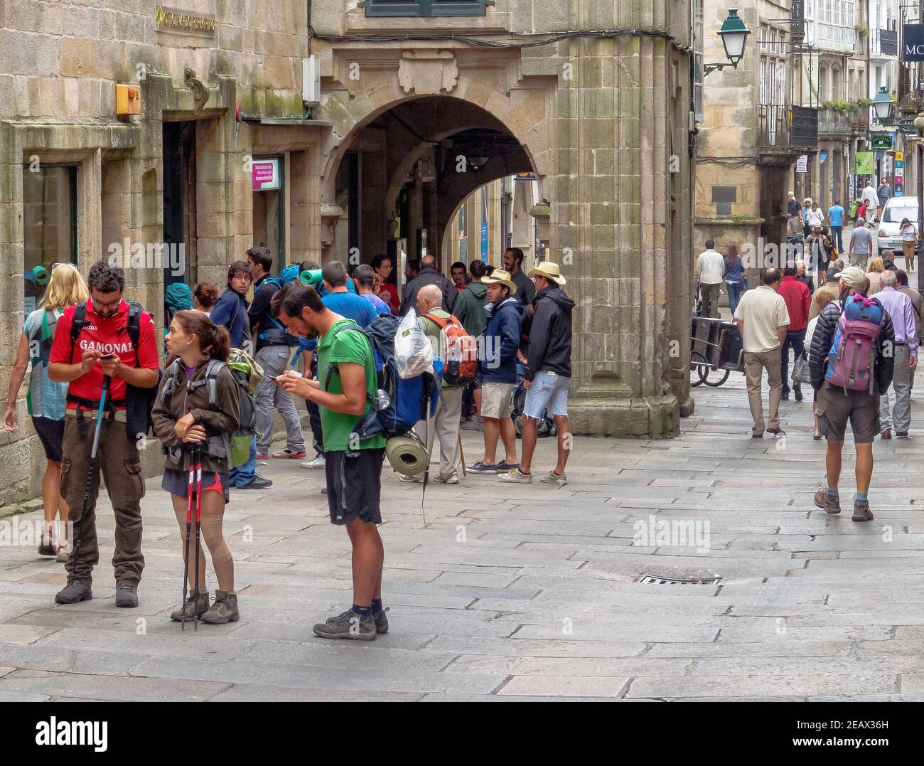 Pilgrims in front of the Pilgrim Office in Vilar Street at the end of their Camino - Santiago de Compostela, Galicia, Spain Stock Photo