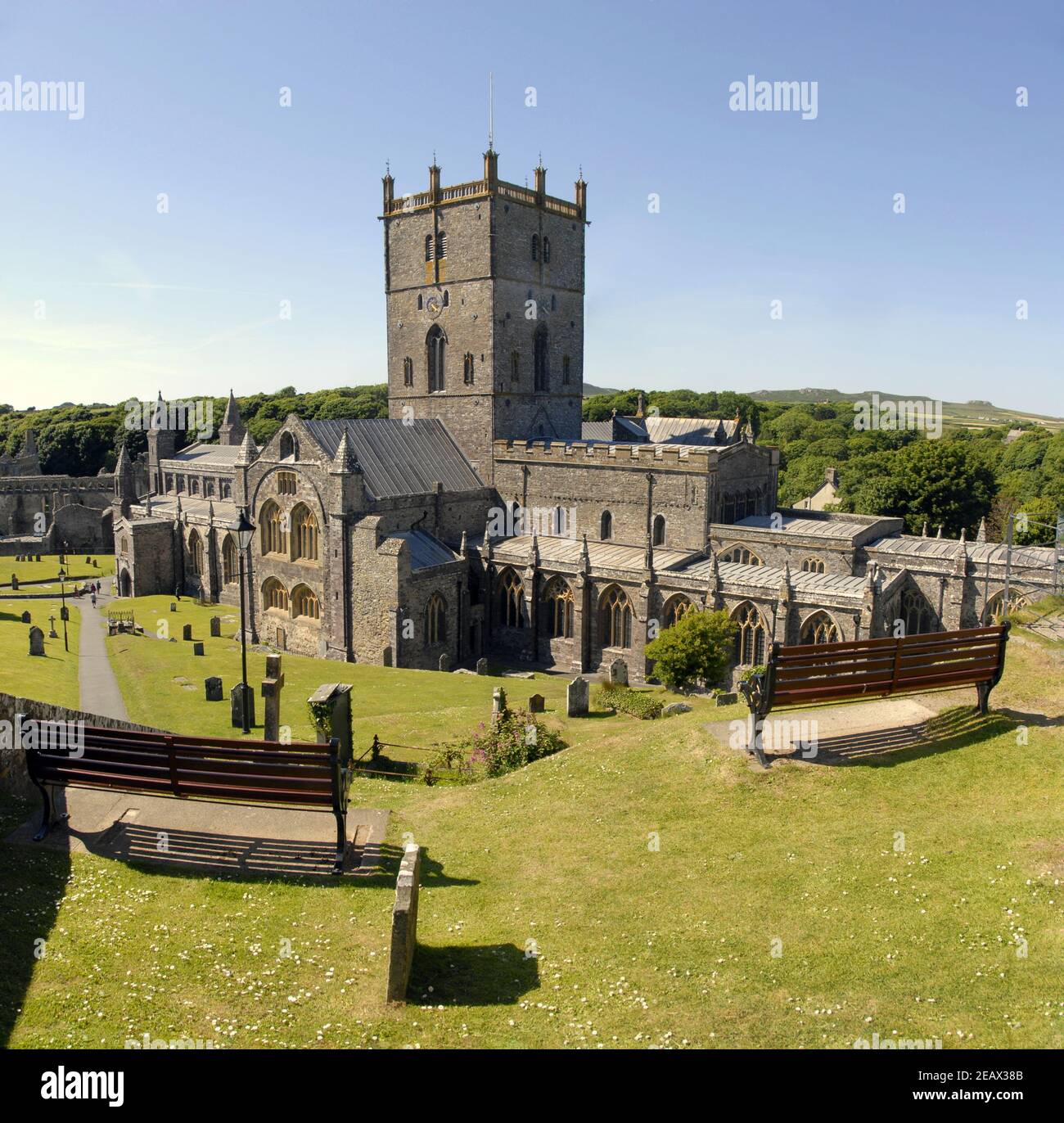 Two wooden seats on higher ground overlooking St David's cathedral, Pembrokeshire, Wales Stock Photo